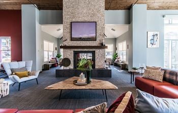 Resident lounge with kitchen, dining space and fireplace